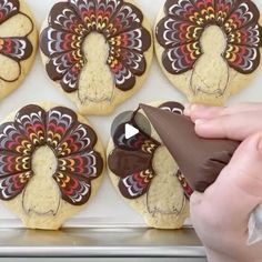 cookies decorated like turkeys with chocolate frosting being drizzled on them