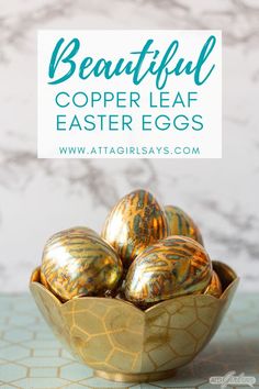 some gold eggs in a bowl with the words beautiful copper leaf easter eggs on it