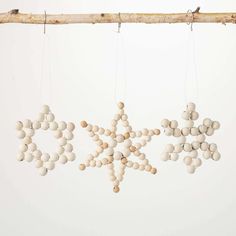 some white balls hanging from a branch with the word sale spelled out in it's center