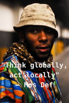 a man wearing a hat and scarf on the street