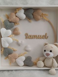 a crocheted teddy bear in a box with the name samuel written on it