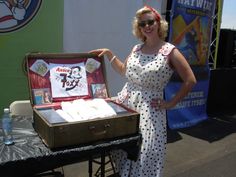 a woman standing next to an open suitcase