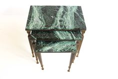 three green marbled tables stacked on top of each other