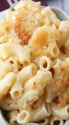 a bowl filled with macaroni and cheese on top of a table