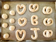 pretzels are arranged on a baking sheet to spell out the letter g and t