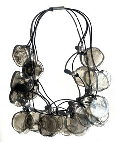 a black and white necklace with lots of glass beads