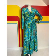 70s Botanical Wrap Maxi Dress By Rona New York, One Of The Big Higher End 7th Avenue Ready To Wear Houses. For Bonwit Teller That Omnipresent 70s Style - The Wrap Dress! Comfy And Flattering Nylon Spandex Jersey Fringe Belt This Awesome Blue And Green Fern Botanical Print Excellent Condition. Small Hole Near The Waistband At The Front Bust 32-34 Waist 25-28 Hips 40 Shoulder To Waist 15 Total Length 57 Fitted Long Wrap Dress For Spring, Retro Blue Maxi Dress For Spring, Blue Retro Maxi Dress For Spring, Vintage Long Green Dress, Blue Vintage Maxi Dress For Spring, Vintage Blue Maxi Dress For Spring, Fitted Long Retro Dress, Blue Dresses With Vintage Print For Spring, Retro Blue Spring Maxi Dress