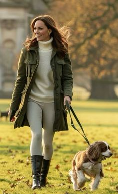 a woman walking her dog in the park