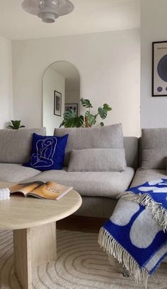 a living room filled with furniture and a round coffee table