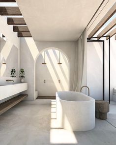 a large white bath tub sitting next to a sink in a bathroom under a window