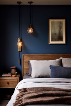 a bed in a bedroom with blue walls and two lamps hanging from the ceiling above it