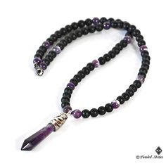 The centerpiece of this long gemstone men's necklace is an Amethyst healing point pendant. The combination of black matte onyx and shiny purple striped amethyst beads creates balanced, manly and sophisticated look. This piece is perfect for making a statement effortlessly and stylishly. This necklace is strung on a beaded wire and finished off with a lobster claw clasp. You can select the necklace length from the drop-down menu on the right. The pendant measures approximately 2.36 inches long (6 Black Gemstone Crystal Necklace For Spiritual Use, Black Spiritual Crystal Necklace With Gemstone, Spiritual Black Crystal Necklace With Gemstone, Spiritual Black Gemstone Crystal Necklace, Spiritual Obsidian Necklace With Gemstone, Spiritual Obsidian Gemstone Necklace, Black Crystal Pendant Necklaces For Meditation, Black Pendant Crystal Necklaces For Meditation, Black Pendant Crystal Necklace For Meditation