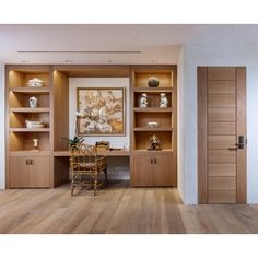 a room with wooden floors and shelves filled with vases