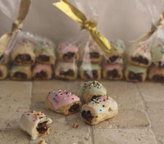 small pastries with sprinkles are on the floor next to some bags