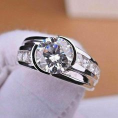 a close up of a ring with a diamond on it