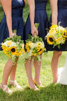 the bridesmaids are holding sunflower bouquets in their dresses and shoes,