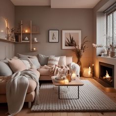 a living room filled with lots of furniture and candles on top of a table in front of a fire place