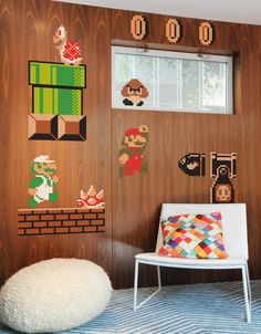 a nintendo themed room with mario and luigi's bedroom decorations on the wall, along with a white chair