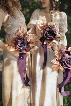 two bridesmaids holding bouquets of flowers in their hands