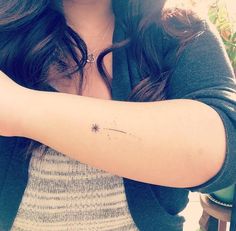 a woman with a small star tattoo on her arm