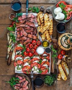 a table full of food on top of a wooden table