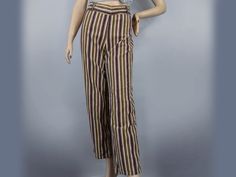 This fun pair of vintage 60s pants are a bold statement piece! The coloring is reminiscent of Neapolitan ice cream, with chocolate brown, strawberry pink, and vanilla cream...with a bit of lemon yellow for good measure. The stripes are not only fun colors, they are lines of corduroy fabric, so they have a fun ridged texture, as well as a soft fuzzy feel.   The wide waistband has a slight V-dip at the front and back, plus loops for a belt, if you choose to add one. It closes at the side with snaps and a zipper. The legs are a fairly straight cut from hip to hem. Shallow scoop pockets set at the front hip on each side.   These are nicely made, judging from a sewing standpoint, with care taken to match the lines as they meet at the center seams, along the leg, and along the inseam. It's not s Retro Brown Bottoms For Spring, Retro Brown Pants For Spring, Vintage Striped Fitted Pants, Vintage Striped Pants For Spring, Vintage Multicolor Spring Pants, Vintage Multicolor Straight Leg Pants, Vintage Multicolor Cotton Pants, Multicolor Vintage Straight Leg Pants, Vintage Striped Pants For Summer