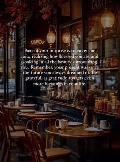 a restaurant with tables and chairs in front of the window that says, part of your purpose is to enjoy the now realizing how