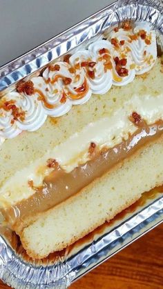 a piece of cake sitting on top of a metal pan covered in frosting and toppings