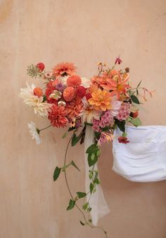 a bouquet of flowers is hanging on the wall