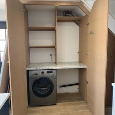 a washer and dryer in a small room with no doors on the walls