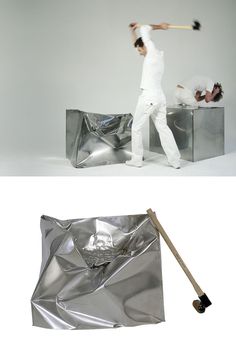 a man holding a baseball bat standing next to a silver bag with a woman on it