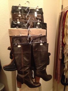 several pairs of boots are hanging on a rack