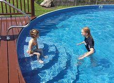 two young children playing in a swimming pool