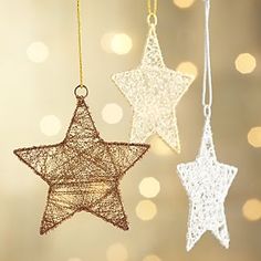 three white and gold stars hanging from strings