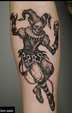 a black and white photo of a tattoo on someone's leg with an image of a clown