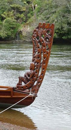 a wooden boat sitting on top of a river