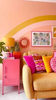 a living room filled with lots of colorful pillows and decor on top of a yellow couch