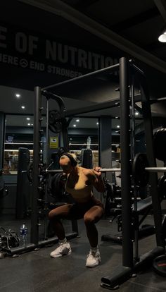 a woman doing squats in the gym