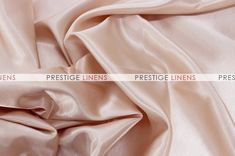 a close up view of a satin fabric with the words prestige linens on it