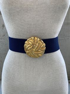 "Navy blue retro elastic belt, 80s vintage cinch belt, blue waist belt, metal gold tone knot chunky buckle, statement belt, maximalist style Gorgeous belt, with all the fun that I've come to expect from vintage accessories.  Gold tone know metal buckle. Belt elastic is Navy blue. Perfect for adding a bit of shine and texture to any outfit Circa 1980s Measures: Long 29 3/4\" stretches to 44\" Wide 2\" Buckle 3\" x 3\" In great vintage condition * Visit the shop * https://www.etsy.com/shop/KernelKernelVintage * Follow us on instagram * @kernelkernelvintage ------------------------------------------------------ All sales are FINAL, I don't accept returns, exchanges, or cancellations. We take great care in providing many photos, detailed measurements, and descriptions for all of our products; Adjustable Gold Fabric Belt, Navy Blue Outfit, Maximalist Style, Cinch Belt, Statement Belt, Boho Belts, Summer Handbags, Concho Belt, Accessories Gold