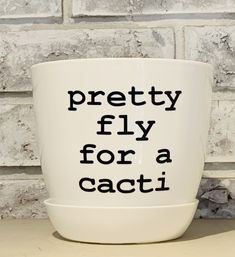 a white coffee cup with the words pretty fly for a cacti printed on it