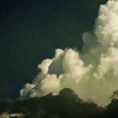 an airplane is flying through the clouds in the sky