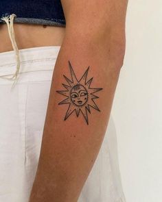 a person with a sun tattoo on their arm