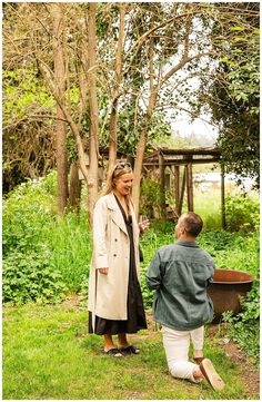 a man and woman standing next to each other in the grass