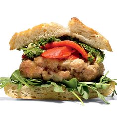 a sandwich with meat, lettuce and tomatoes