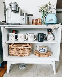 a shelf with coffee mugs and baskets on it