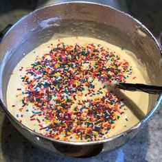 a pan filled with cake batter and sprinkles