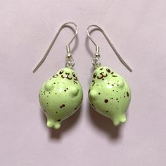 Pastel green baby seal earrings inspired by speckled chocolate eggs! Handmade with polymer clay, acrylic paint, gloss varnish and lots of love. <3 Each seal measures roughly 2cm in height and 1.5cm in width. Made with top quality hypoallergenic earring hooks (surgical steel earwires with gold or silver plating.) Clip-on earrings are now also available as an option for everyone to enjoy! (see last image for example). *As each set is a unique, hand crafted piece, details may vary slightly from the Seal Earrings, Easter Egg Earrings, Egg Earrings, Baby Seal, Surgical Steel Earrings, Chocolate Eggs, Animal Earrings, Green Baby, Hypoallergenic Earrings