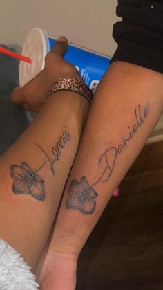 two people with matching tattoos on their legs, one has the word danielle written in cursive writing