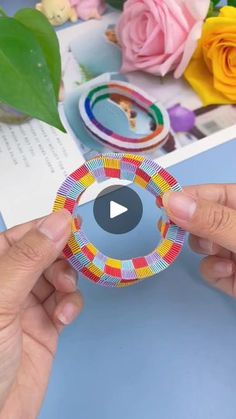 someone is holding up a colorful paper circle